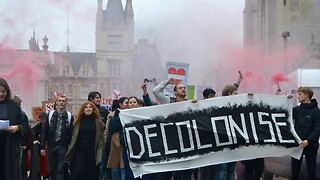 Students rally through Cambridge in protest of arms and fossil fuels connections 