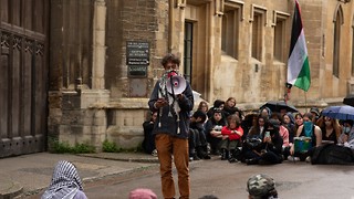 Activists stage sit-in outside Old Schools entrance